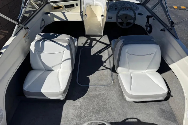 Slide: The Image of 2006 Bayliner 175 XT boat interior with white seats and steering wheel. - 8