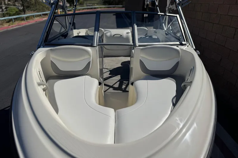 Slide: The Image of 2006 Bayliner 175 XT boat interior with white seating and windshield. - 9