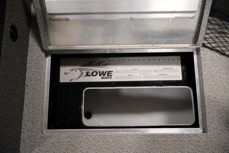 Slide: The Image of 2024 Lowe Fishing Machine 1775WT storage compartment with integrated measuring ruler. - 18