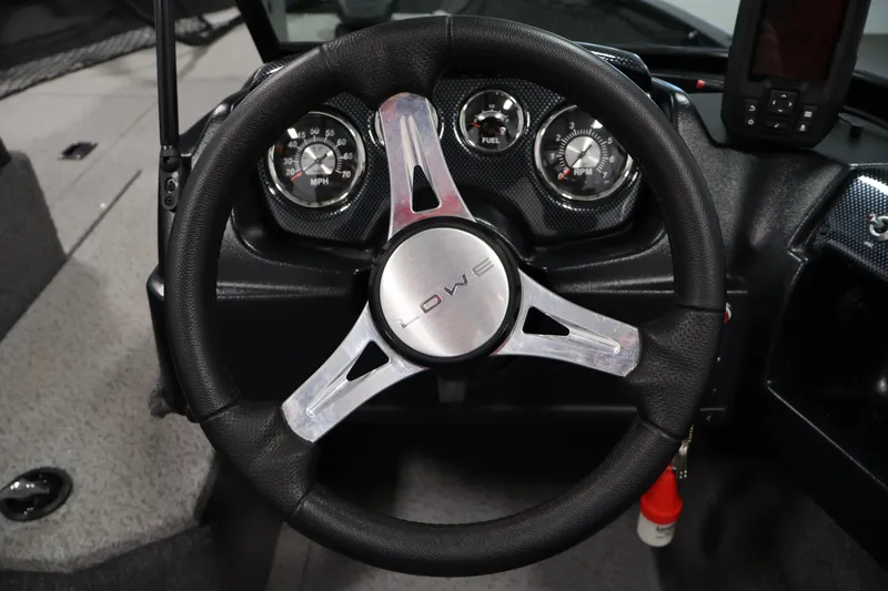 Slide: The Image of Steering wheel and dashboard of 2024 Lowe Fishing Machine 1775WT boat. - 23