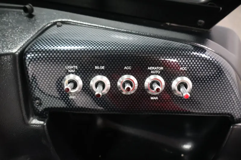 Slide: The Image of Control panel of 2024 Lowe Fishing Machine 1775WT with switches for lights, bilge, and aerator. - 26