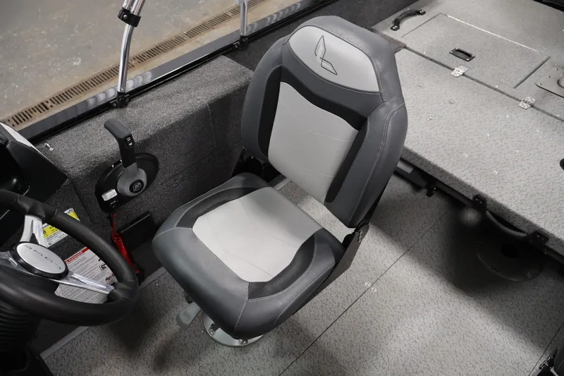 Slide: The Image of 2024 Lowe Fishing Machine 1775WT interior with gray seating and steering controls. - 28
