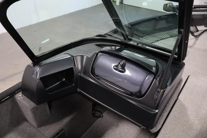 Slide: The Image of 2024 Lowe Fishing Machine 1775WT interior dashboard with windshield and storage compartment. - 29