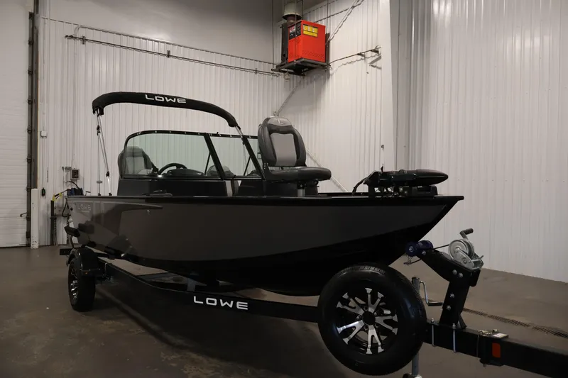 Slide: The Image of 2024 Lowe Fishing Machine 1775WT boat in a garage setting. - 3