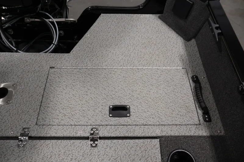 Slide: The Image of 2024 Lowe Fishing Machine 1775WT boat interior with storage compartment and handle. - 33