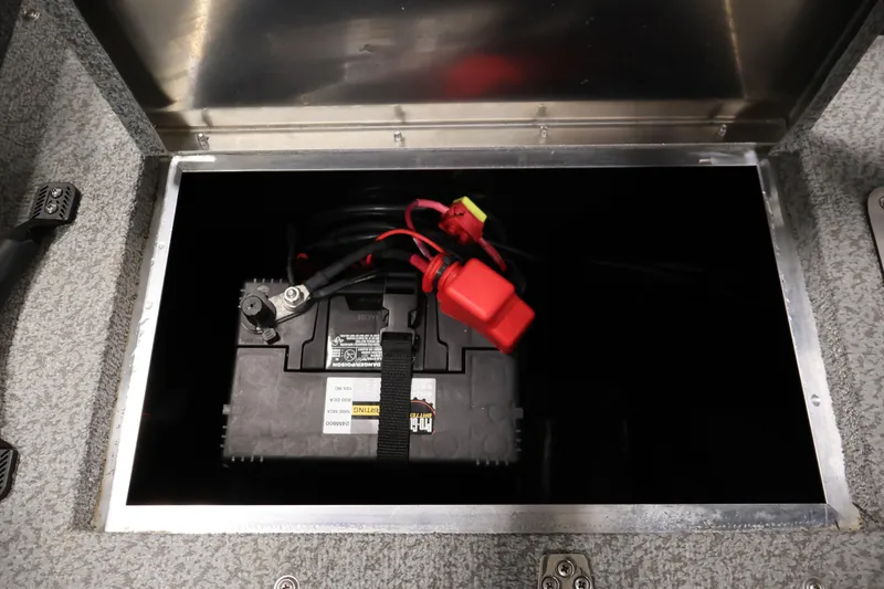 Slide: The Image of Battery compartment of 2024 Lowe Fishing Machine 1775WT boat, featuring secure battery setup. - 36