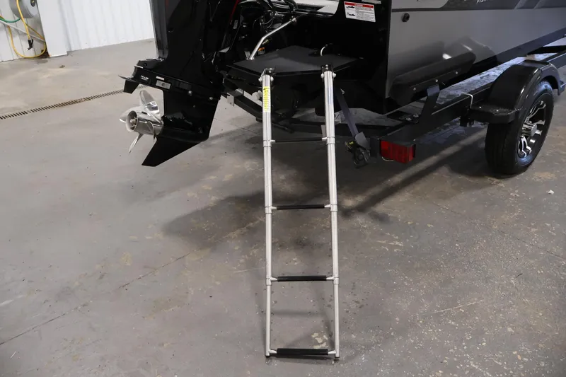 Slide: The Image of 2024 Lowe Fishing Machine 1775WT boat with ladder and trailer in a garage. - 39