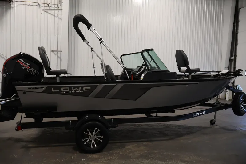 Slide: The Image of 2024 Lowe Fishing Machine 1775WT boat in a showroom, side view. - 4