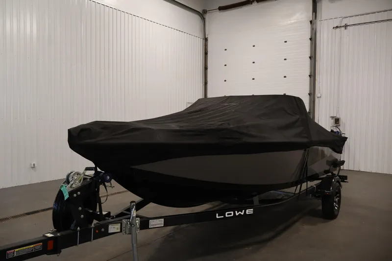 Slide: The Image of 2024 Lowe Fishing Machine 1775WT boat covered in a garage setting. - 48