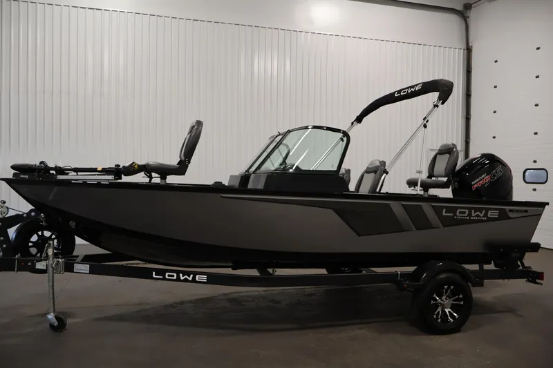 Slide: The Image of 2024 Lowe Fishing Machine 1775WT boat in showroom, side view, on trailer. - 8