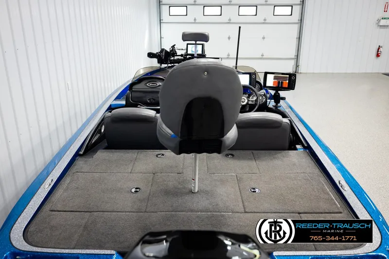 Slide: The Image of 2008 Triton 20X2 DC boat interior with fishing seats and control panel in a garage. - 12