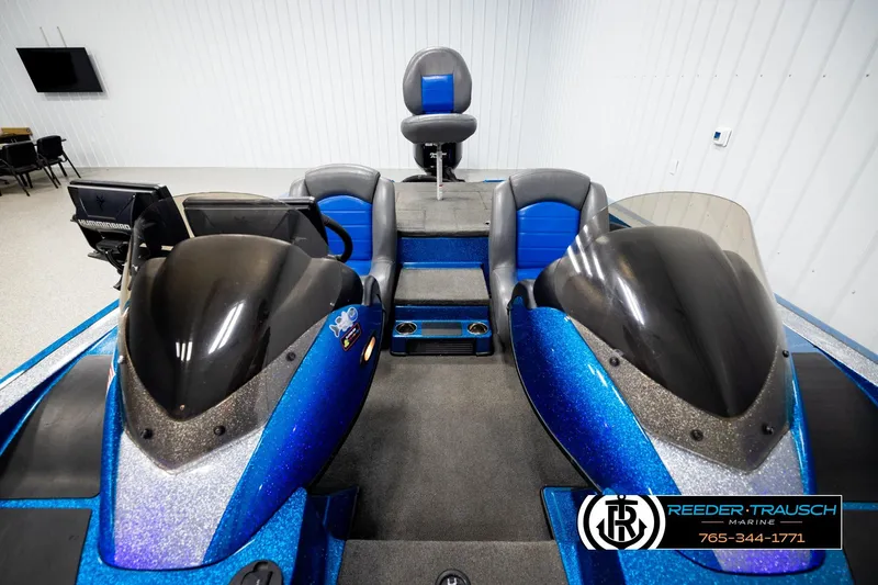 Slide: The Image of 2008 Triton 20X2 DC boat interior with blue and black seating, dual consoles, and steering wheel. - 16