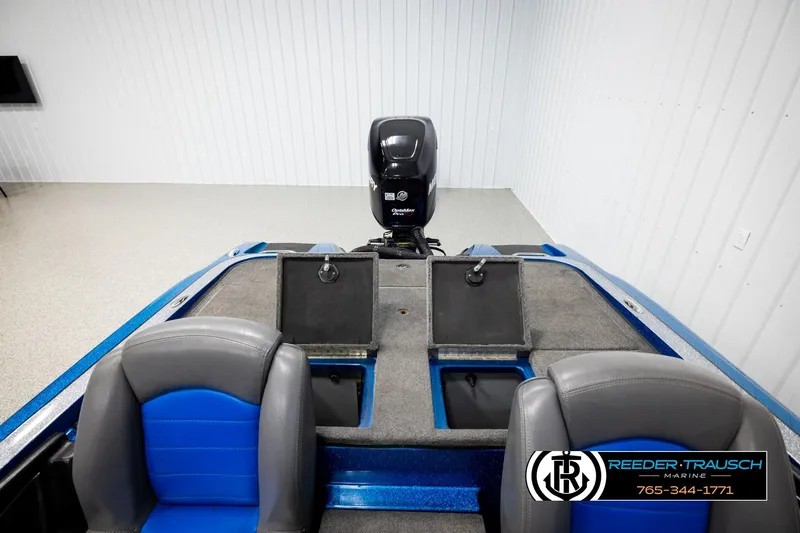 Slide: The Image of 2008 Triton 20X2 DC boat interior with seats and motor in a showroom. - 19