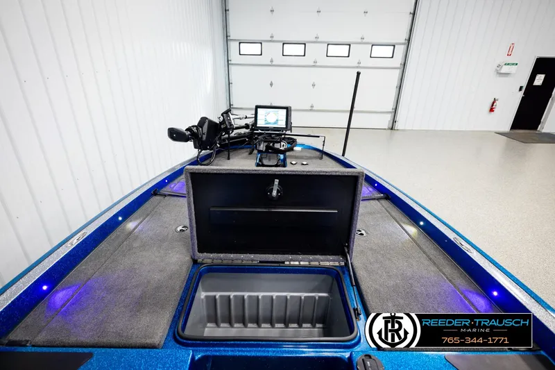 Slide: The Image of 2008 Triton 20X2 DC boat interior with open storage compartment and navigation equipment. - 23