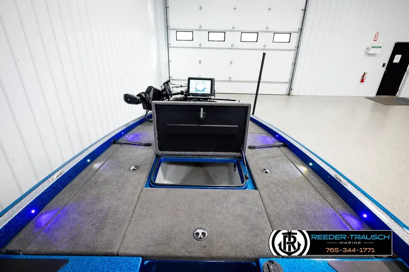 Slide: The Image of 2008 Triton 20X2 DC boat interior with open storage compartment and navigation equipment. - 24