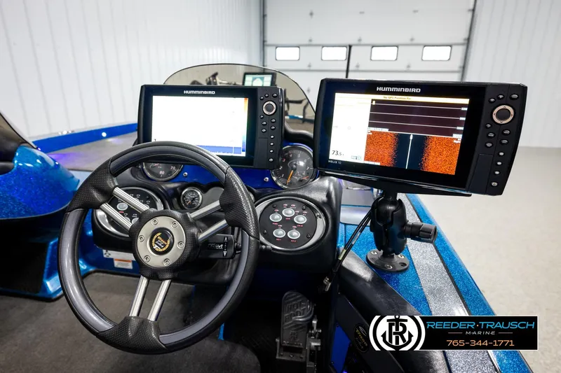 Slide: The Image of 2008 Triton 20X2 DC boat dashboard with dual Humminbird fish finders and steering wheel. - 26