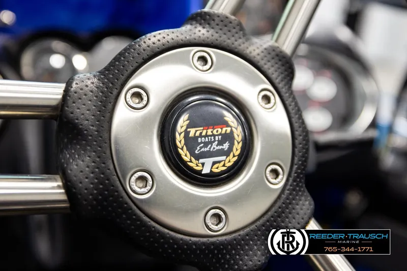 Slide: The Image of Steering wheel of 2008 Triton 20X2 DC boat with logo and branding details. - 28