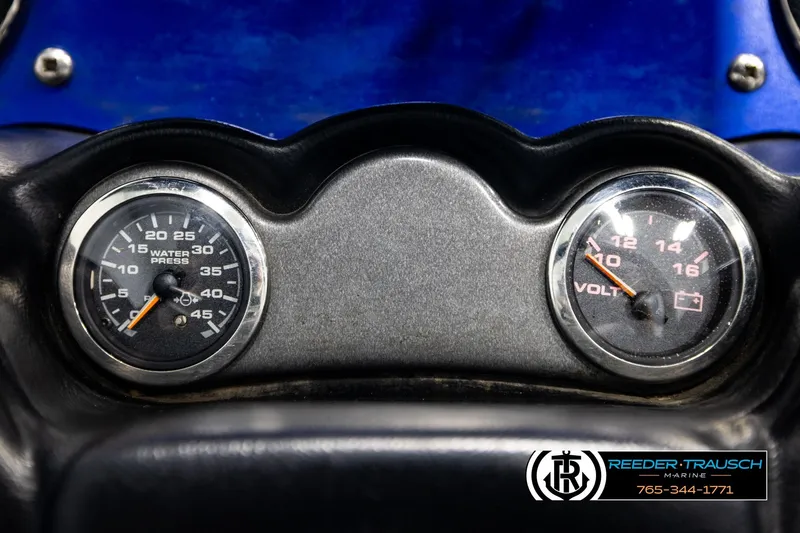 Slide: The Image of 2008 Triton 20X2 DC dashboard with water pressure and volt gauges. - 32