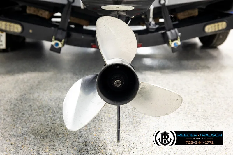 Slide: The Image of 2008 Triton 20X2 DC boat propeller close-up in a showroom setting. - 52