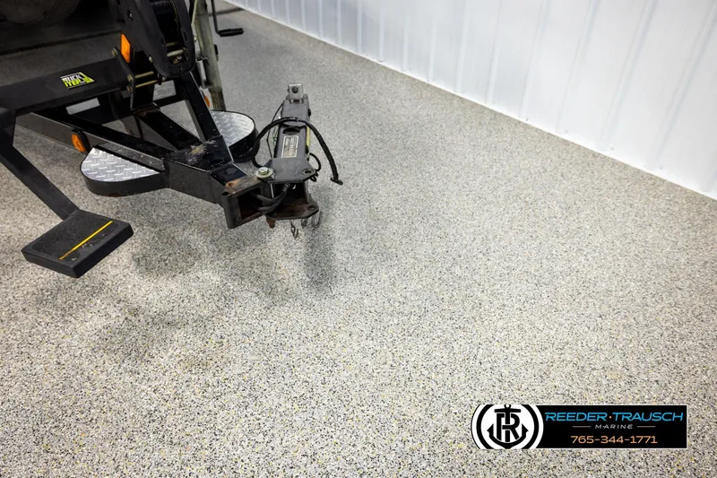 Slide: The Image of Trailer hitch of a 2008 Triton 20X2 DC on speckled garage floor. - 53