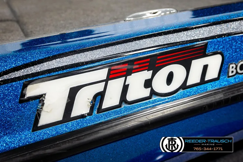 Slide: The Image of Close-up of 2008 Triton 20X2 DC boat logo on a blue metallic surface. - 56