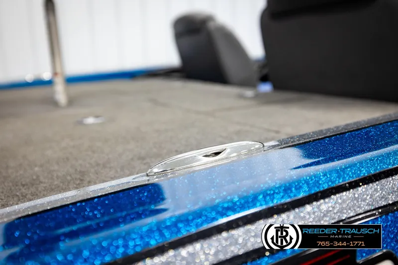 Slide: The Image of 2008 Triton 20X2 DC boat deck with blue metallic finish, Reeder-Trausch Marine logo visible. - 58