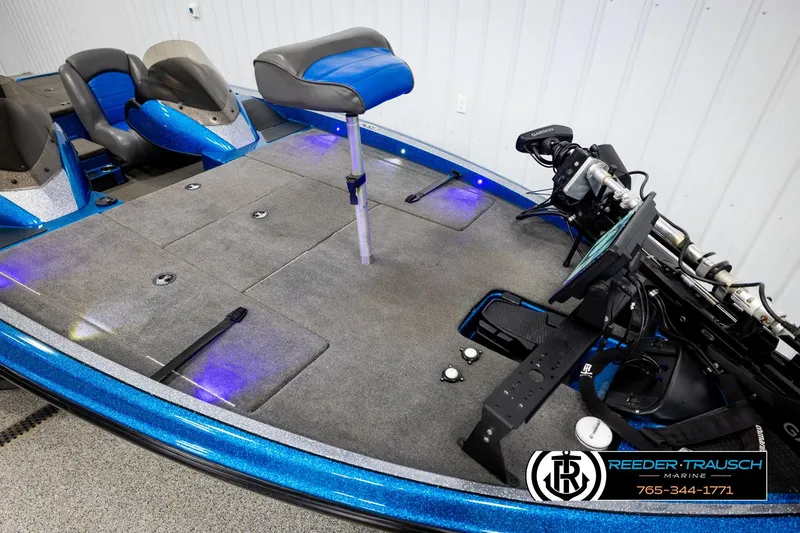 Slide: The Image of 2008 Triton 20X2 DC boat interior with blue accents and fishing equipment. - 8