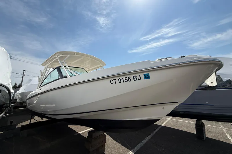 Slide: The Image of 2016 Boston Whaler 270 Vantage boat on display under a clear blue sky. - 14