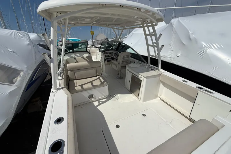Slide: The Image of 2016 Boston Whaler 270 Vantage boat interior with seating and helm, docked in marina. - 16