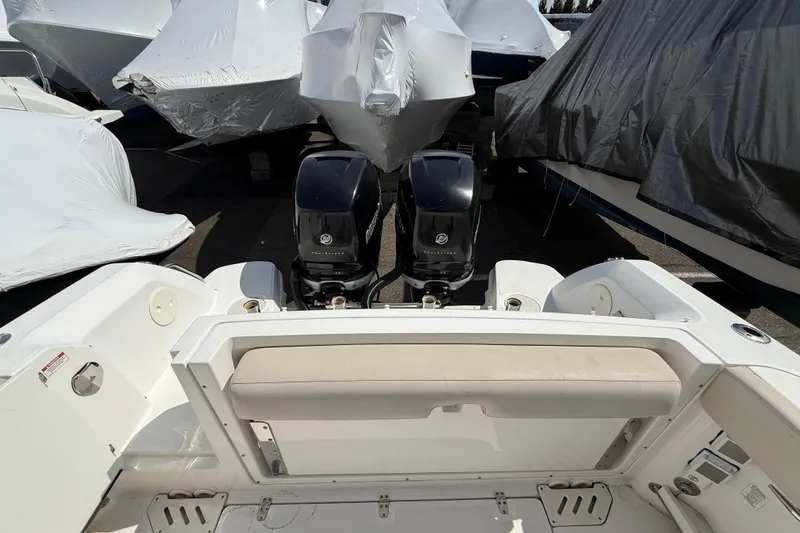 Slide: The Image of 2016 Boston Whaler 270 Vantage boat with dual engines, covered in storage. - 18