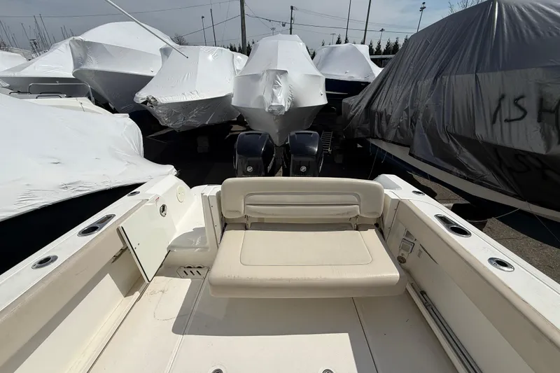 Slide: The Image of 2016 Boston Whaler 270 Vantage boat, covered and stored, with visible seating area. - 20