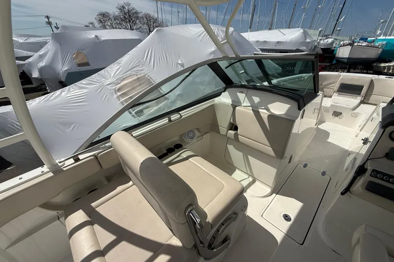 Slide: The Image of 2016 Boston Whaler 270 Vantage boat interior with seating and covered boats in background. - 23