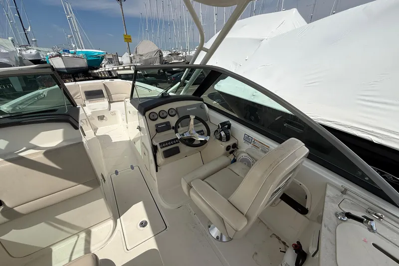 Slide: The Image of 2016 Boston Whaler 270 Vantage boat interior with steering wheel and seating. - 24