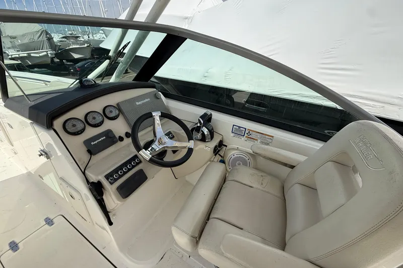 Slide: The Image of 2016 Boston Whaler 270 Vantage helm with steering wheel and control panel. - 26