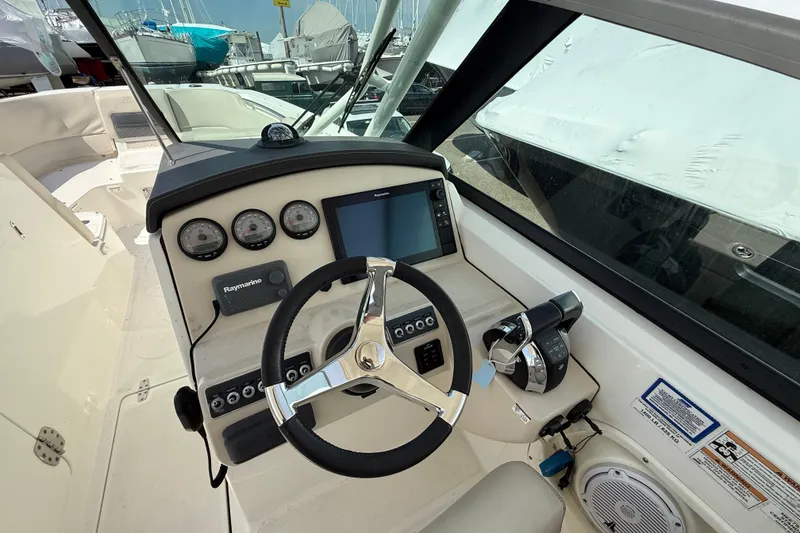 Slide: The Image of Helm of 2016 Boston Whaler 270 Vantage with steering wheel and navigation controls. - 27