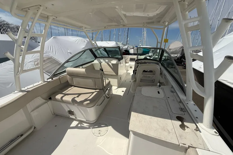 Slide: The Image of 2016 Boston Whaler 270 Vantage boat interior with seating and helm, docked outdoors. - 30