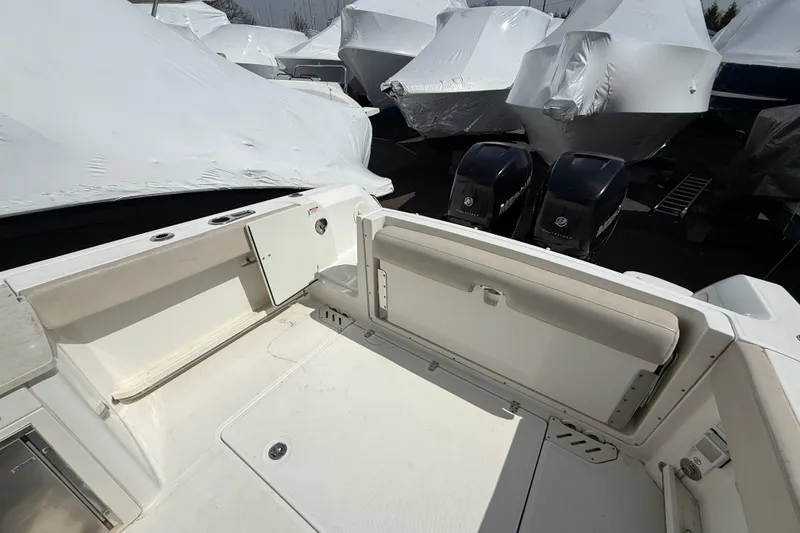 Slide: The Image of 2016 Boston Whaler 270 Vantage boat deck with covered boats in background. - 39