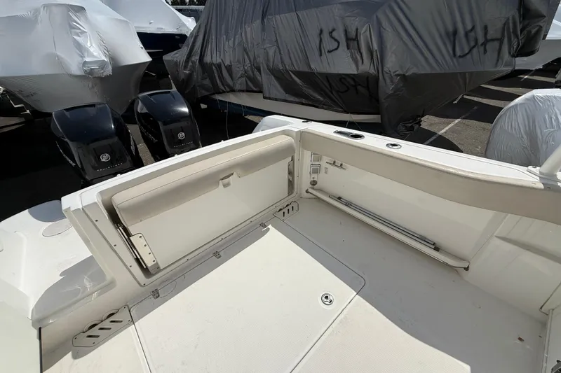 Slide: The Image of 2016 Boston Whaler 270 Vantage boat interior with seating and dual outboard engines. - 40