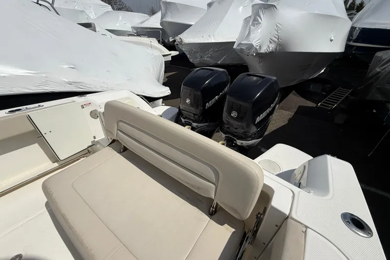 Slide: The Image of 2016 Boston Whaler 270 Vantage boat with dual Mercury engines, docked and covered. - 41