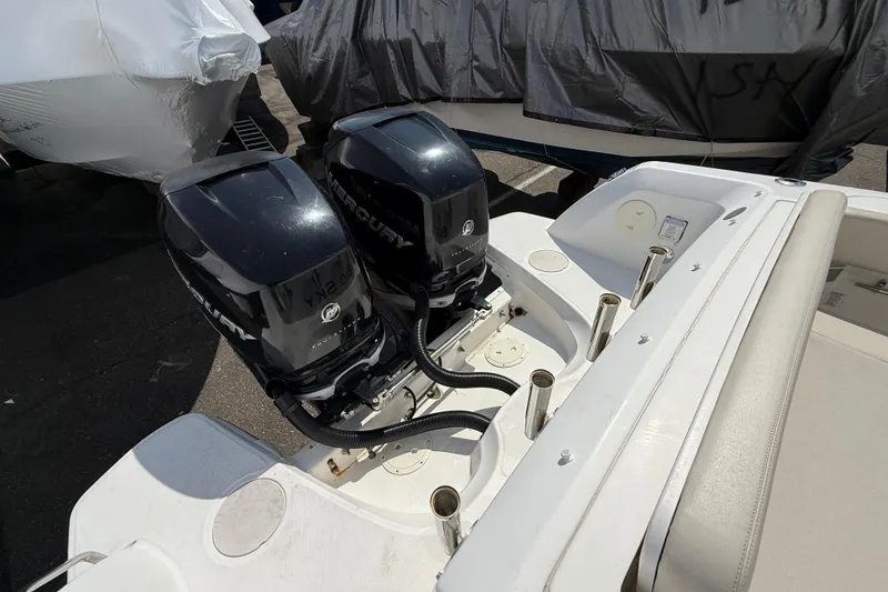 Slide: The Image of 2016 Boston Whaler 270 Vantage with dual Mercury outboard engines, docked and covered. - 42