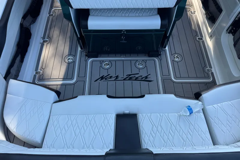 Slide: The Image of 2024 Nor-Tech 400 Supersport boat interior with white seating and branded flooring. - 10