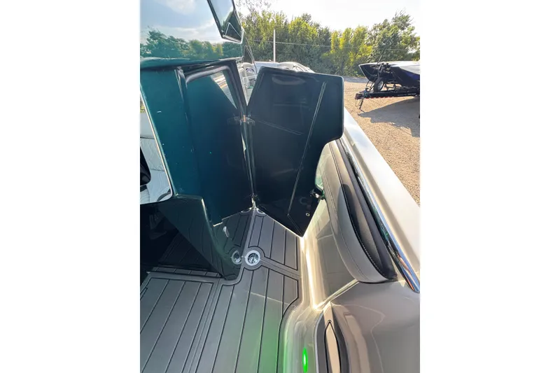 Slide: The Image of 2024 Nor-Tech 400 Supersport boat with open storage compartment, sleek design, and modern features. - 17