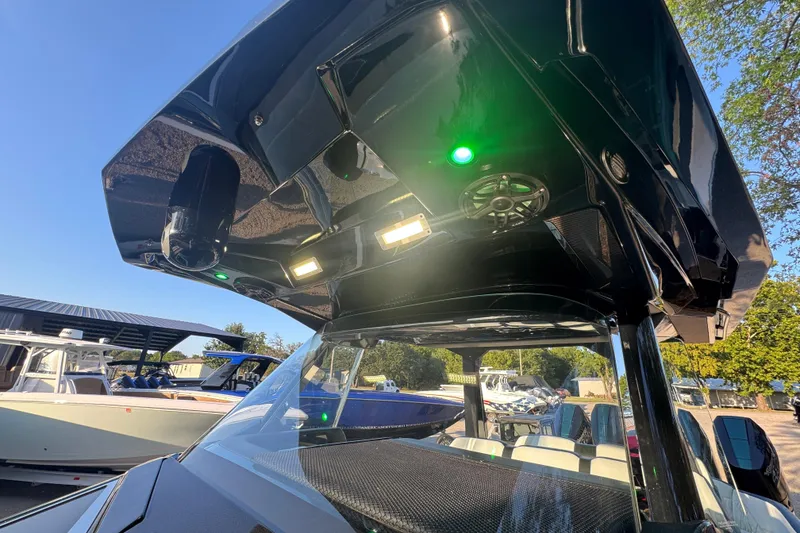 Slide: The Image of 2024 Nor-Tech 400 Supersport boat with illuminated canopy and sleek design. - 24