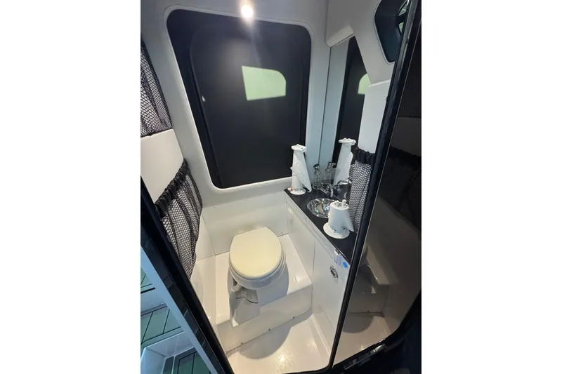Slide: The Image of 2024 Nor-Tech 400 Supersport boat bathroom with modern amenities and sleek design. - 28