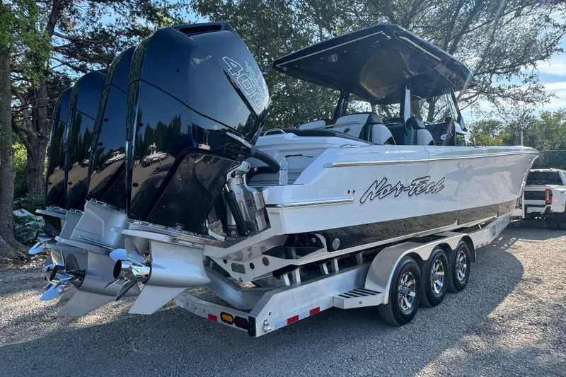 Slide: The Image of 2024 Nor-Tech 400 Supersport boat on trailer, featuring powerful outboard engines. - 4
