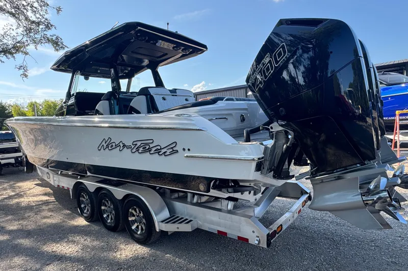 Slide: The Image of 2024 Nor-Tech 400 Supersport boat with powerful outboard engine on a trailer. - 6
