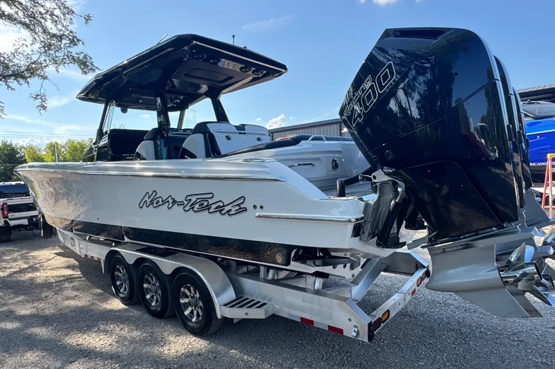Slide: The Image of 2024 Nor-Tech 400 Supersport boat on trailer, featuring powerful outboard engine. - 7