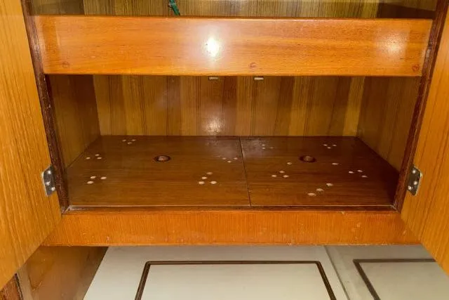 Slide: The Image of Wooden cabinet interior of 1980 Mao Ta Skye 51 yacht, featuring shelves and storage space. - 11