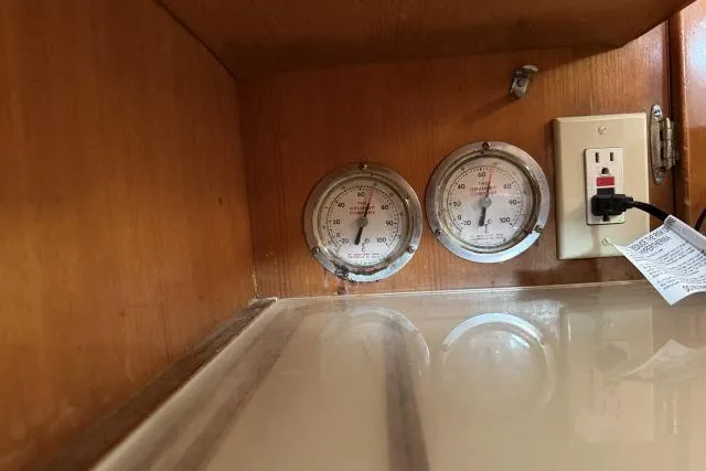 Slide: The Image of Wooden interior with gauges and outlet in 1980 Mao Ta Skye 51 boat. - 13