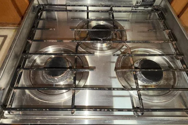 Slide: The Image of Four-burner gas stove, Mao Ta Skye 51, 1980 model, with metal grates and stainless steel surface. - 14